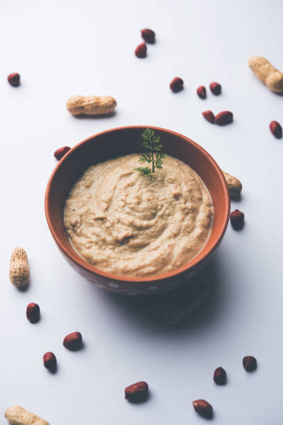 istock Healthy Peanut chutney made using Groundnut / Shengdana or mungfali. served in a small bowl with raw whole. Selective focus 1083213896