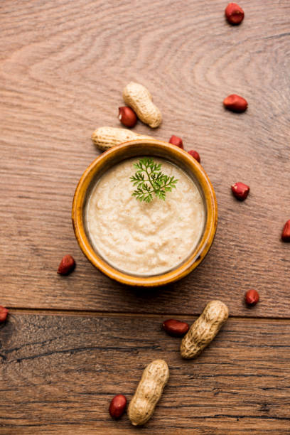 istock Healthy Peanut chutney made using Groundnut / Shengdana or mungfali. served in a small bowl with raw whole. Selective focus 1083213942