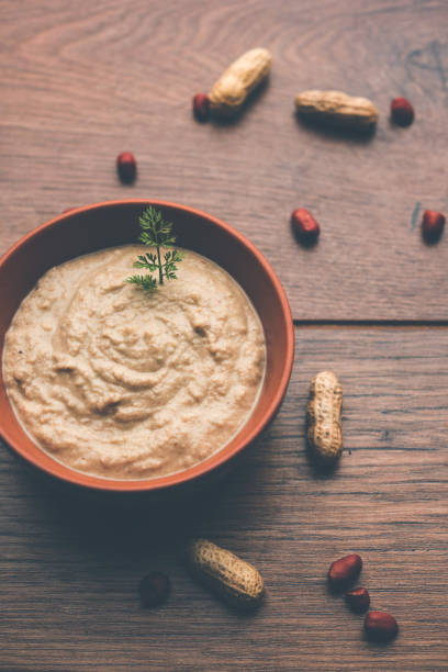 istock Healthy Peanut chutney made using Groundnut / Shengdana or mungfali. served in a small bowl with raw whole. Selective focus 1083215076