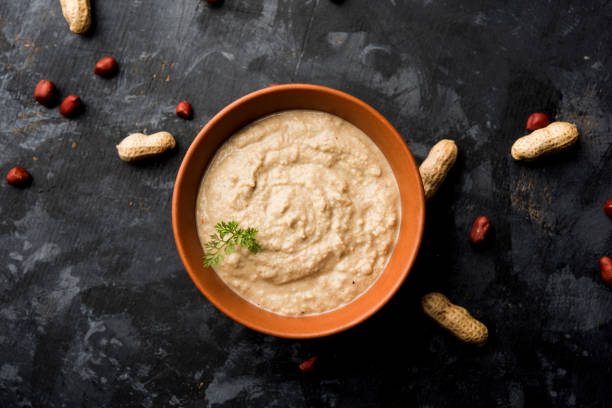 istock Healthy Peanut chutney made using Groundnut / Shengdana or mungfali. served in a small bowl with raw whole. Selective focus 1083216180