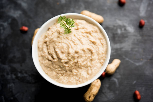 istock Healthy Peanut chutney made using Groundnut / Shengdana or mungfali. served in a small bowl with raw whole. Selective focus 1083216310