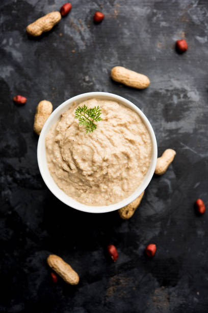 istock Healthy Peanut chutney made using Groundnut / Shengdana or mungfali. served in a small bowl with raw whole. Selective focus 1083216330