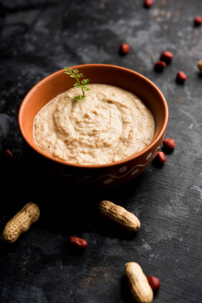istock Healthy Peanut chutney made using Groundnut / Shengdana or mungfali. served in a small bowl with raw whole. Selective focus 1083217902