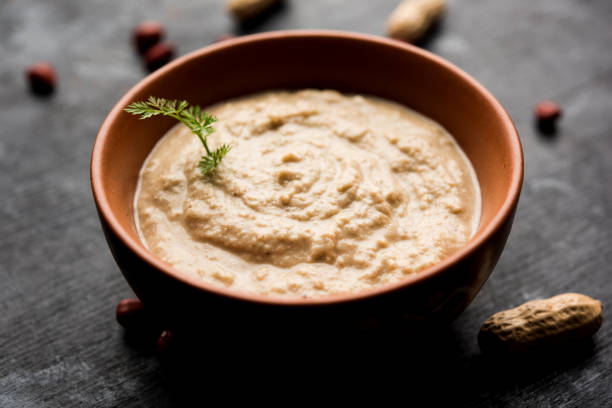 istock Healthy Peanut chutney made using Groundnut / Shengdana or mungfali. served in a small bowl with raw whole. Selective focus 1083217914