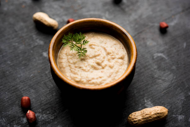 istock Healthy Peanut chutney made using Groundnut / Shengdana or mungfali. served in a small bowl with raw whole. Selective focus 1083218016