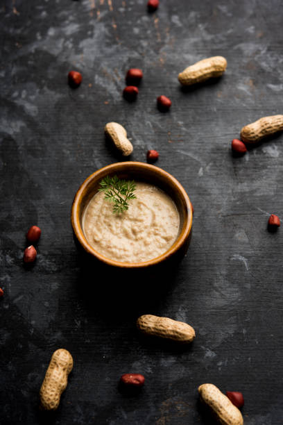 istock Healthy Peanut chutney made using Groundnut / Shengdana or mungfali. served in a small bowl with raw whole. Selective focus 1083218032