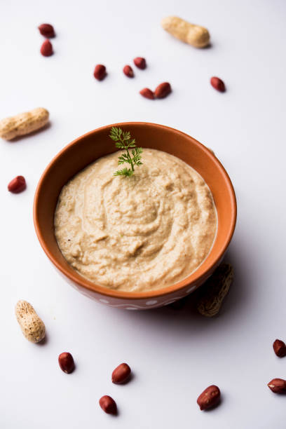 istock Healthy Peanut chutney made using Groundnut / Shengdana or mungfali. served in a small bowl with raw whole. Selective focus 1083218384