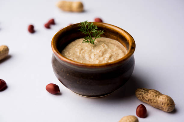 istock Healthy Peanut chutney made using Groundnut / Shengdana or mungfali. served in a small bowl with raw whole. Selective focus 1083218474