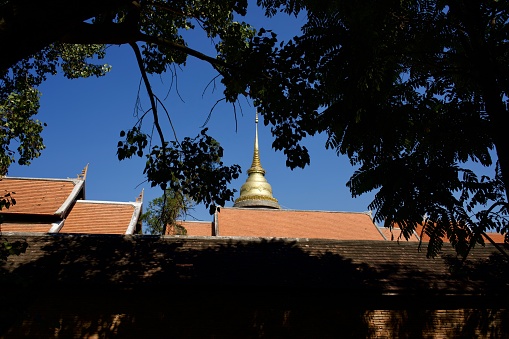 Colorful roofs and tall chedi at Wat Phra That Lampang Luang, a 13th-century Lanna-style Buddhist temple, Lampang, Thailand.