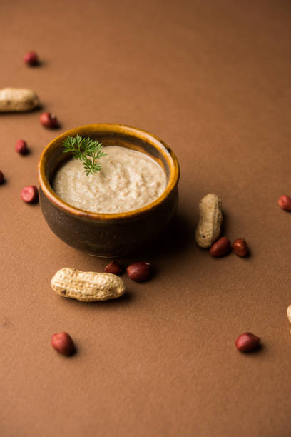 istock Healthy Peanut chutney made using Groundnut / Shengdana or mungfali. served in a small bowl with raw whole. Selective focus 1083219528