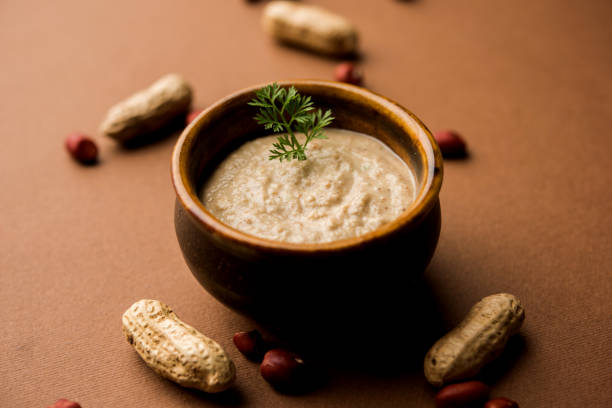 istock Healthy Peanut chutney made using Groundnut / Shengdana or mungfali. served in a small bowl with raw whole. Selective focus 1083219566