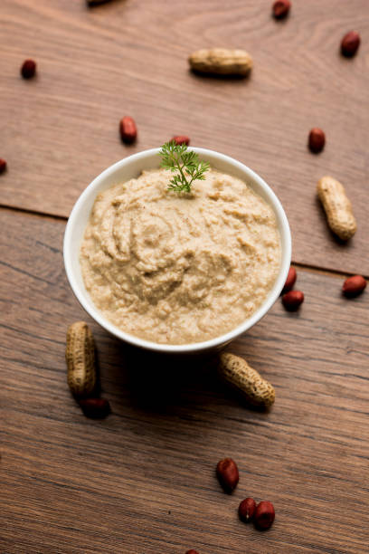 istock Healthy Peanut chutney made using Groundnut / Shengdana or mungfali. served in a small bowl with raw whole. Selective focus 1083219728