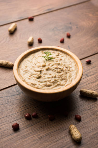 istock Healthy Peanut chutney made using Groundnut / Shengdana or mungfali. served in a small bowl with raw whole. Selective focus 1083220268