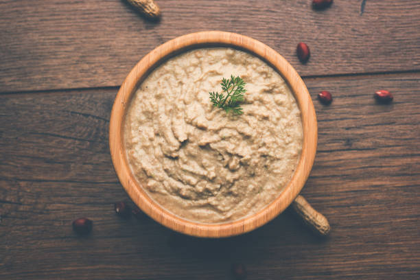 istock Healthy Peanut chutney made using Groundnut / Shengdana or mungfali. served in a small bowl with raw whole. Selective focus 1083220326
