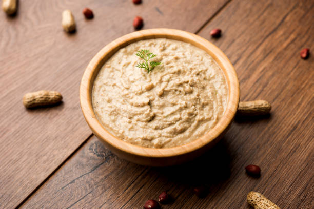 istock Healthy Peanut chutney made using Groundnut / Shengdana or mungfali. served in a small bowl with raw whole. Selective focus 1083220338
