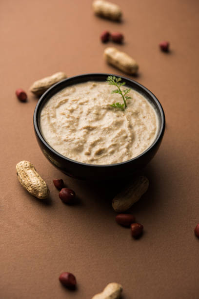 istock Healthy Peanut chutney made using Groundnut / Shengdana or mungfali. served in a small bowl with raw whole. Selective focus 1083221730