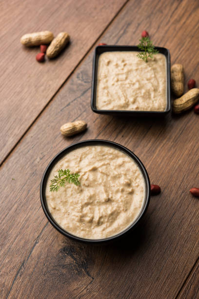 istock Healthy Peanut chutney made using Groundnut / Shengdana or mungfali. served in a small bowl with raw whole. Selective focus 1083221750