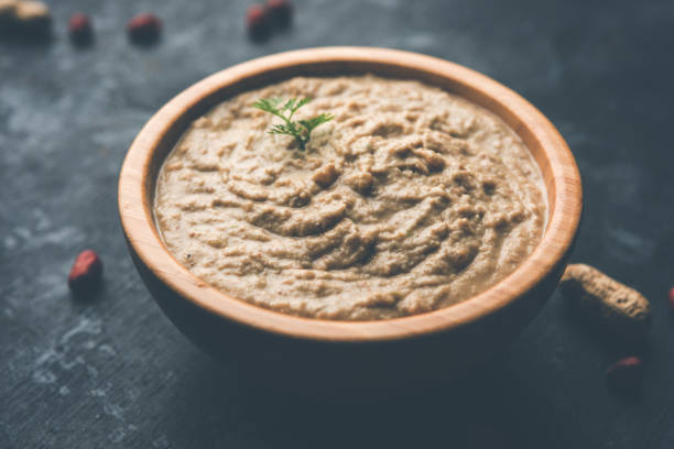 istock Healthy Peanut chutney made using Groundnut / Shengdana or mungfali. served in a small bowl with raw whole. Selective focus 1083221774