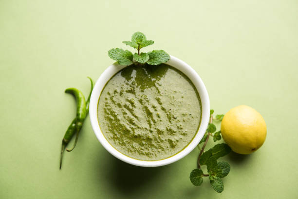 healthy green mint chutney made with coriander, pudina and spices. isolated moody background. selective focus - chutney imagens e fotografias de stock