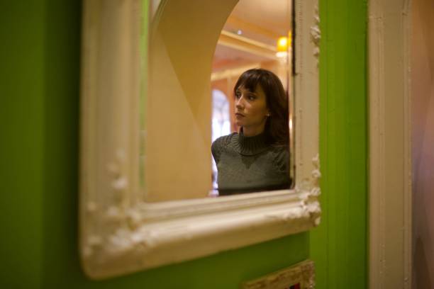 istock young woman with flowers and mirror 1083233138