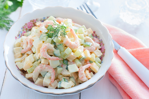 Salad with shrimps, cucumber, eggs and cheese, horizontal