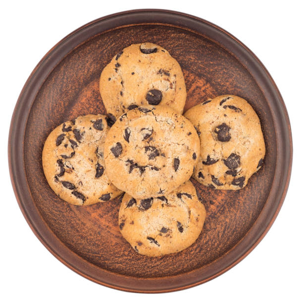 istock Cookies with chocolate in a brown plate. Isolated on white background. Top view. 1083233542