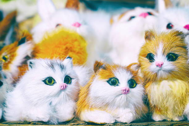 Soft toys kittens sitting in front of the camera