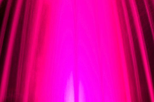 Blurred abstract background the jets of the fountain illuminated by red lanterns