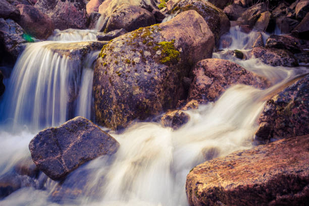 istock Long exposure image of flowing water through rocks 1083239966