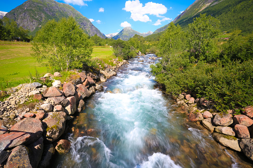 Panoramic, Nature, Scenic - River flowing fast down the mountains and through the side.