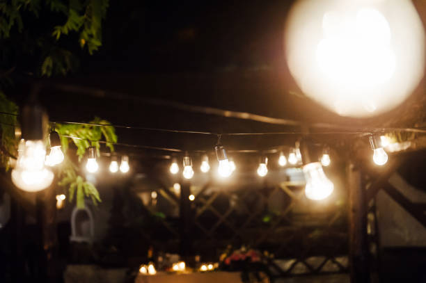 Light bulb decor in outdoor party. Wedding