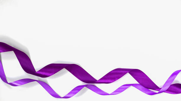 istock Curled violet ribbons on blank white background 1083243772