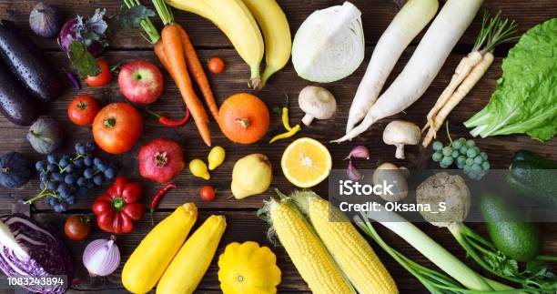 White Yellow Green Orange Red Purple Fruits And Vegetables On Wooden Background Healthy Food Multicolored Raw Food Stock Photo - Download Image Now