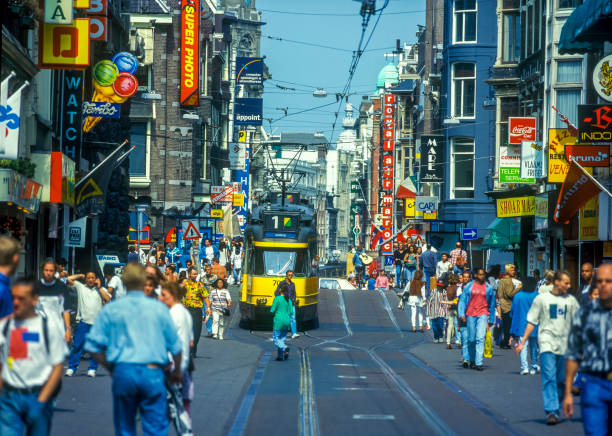 Tourists and locals shopping and strolling on the Leidsestraat (Leidse-street) onto the Leidseplein (Leidse-square). Scan off a 1984 slide.