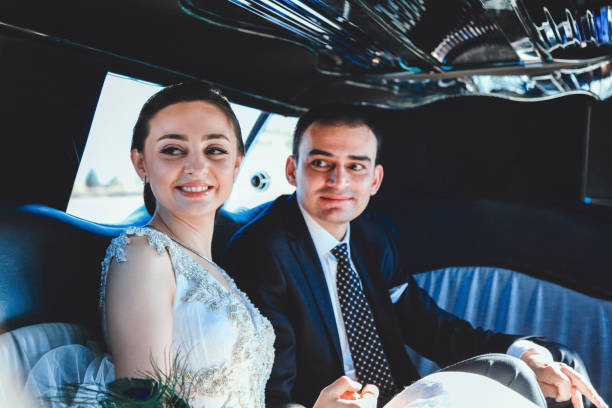 istock Wedding couple inside elegance limousine at their wedding day 1083250454