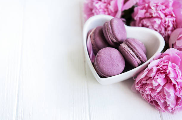 istock Pink peony flowers with macarons 1083253034