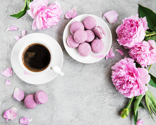 istock Pink peony with coffee and macarons 1083253050