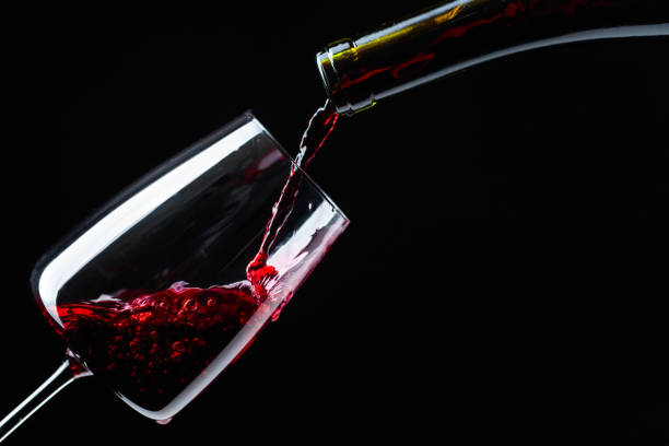 istock Red wine being poured into wineglass. 1083259560