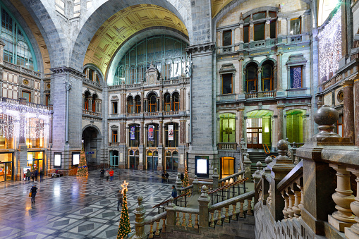 Antwerp, Belgium - December 08, 2018: Outstanding Art Deco entrance hall of Antwerp Central Station. Only a few passengers and visitors in the hall.