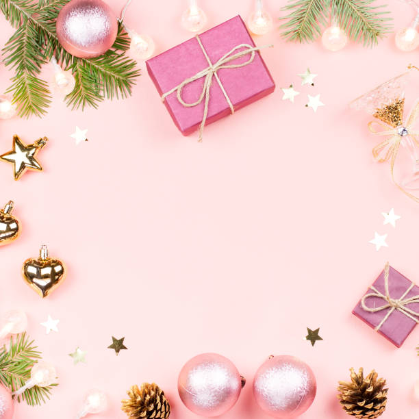 istock Christmas background with fir branches, lights, pink decorations on pink 1083266612