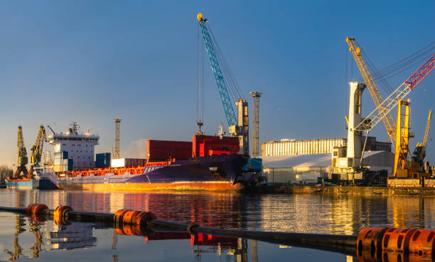 istock ship in the sea port,port cranes unloading containers 1083267902