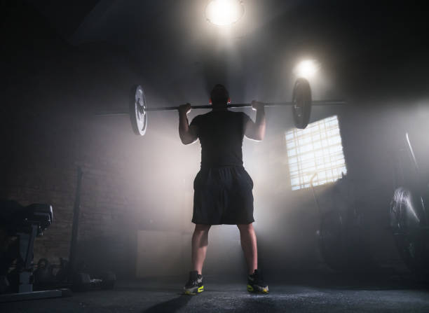 istock Weightlifter flipping two-handed dumbbell 1083268728