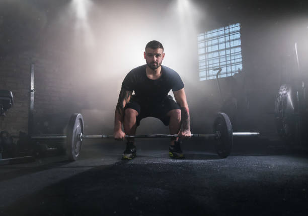 istock Weightlifter flipping two-handed dumbbell 1083268730