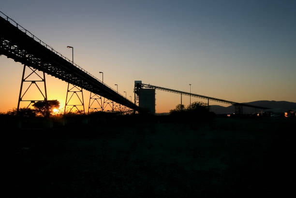 istock Silhouette of a mining silo and conveyor belt 1083272430