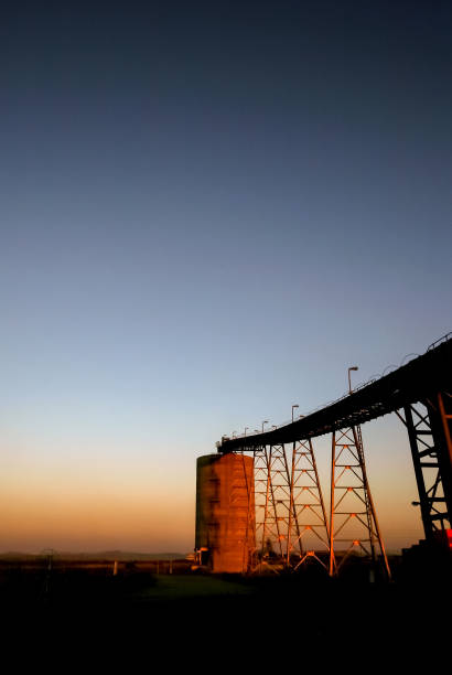 istock Silhouette of a mining silo and conveyor belt 1083272504