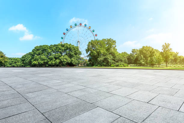 istock Empty floor and ferris wheel in green city park 1083276186