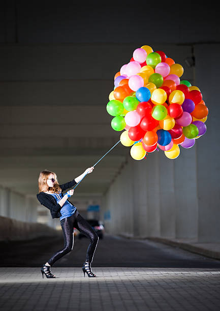 istock Woman holding many balloons 108327652