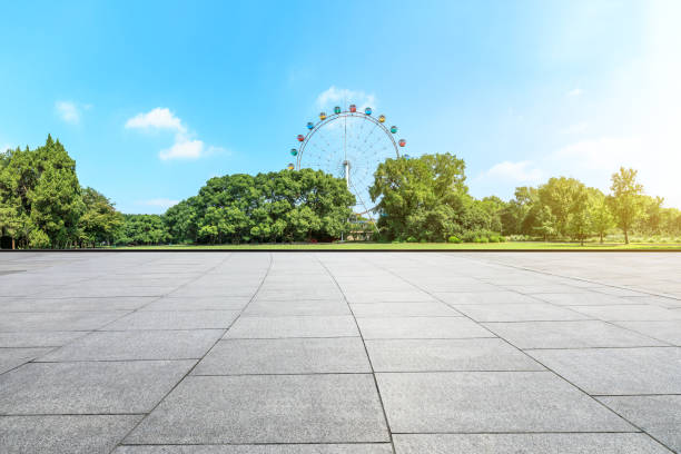 istock Empty floor and ferris wheel in green city park 1083277352