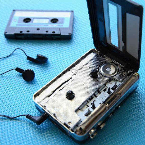 istock A tape cassette player on a blue background. Music playback concept image. 1083277608