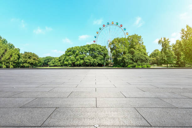 istock Empty floor and ferris wheel in green city park 1083277928